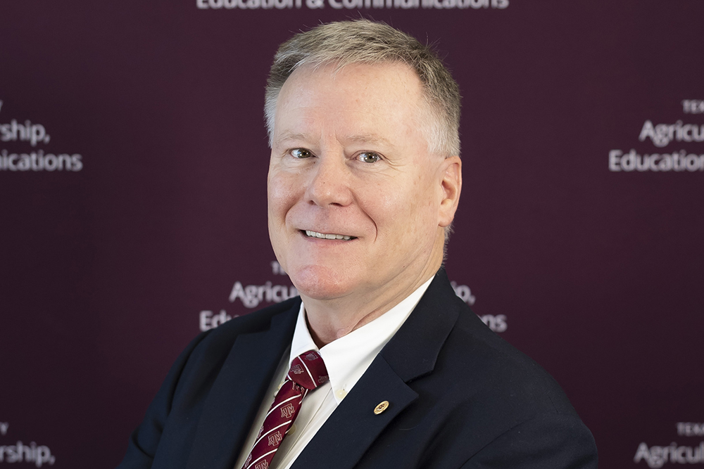 Timothy Murphy, Ph.D. He is wearing a maroon tie and a blue suit jacket.
