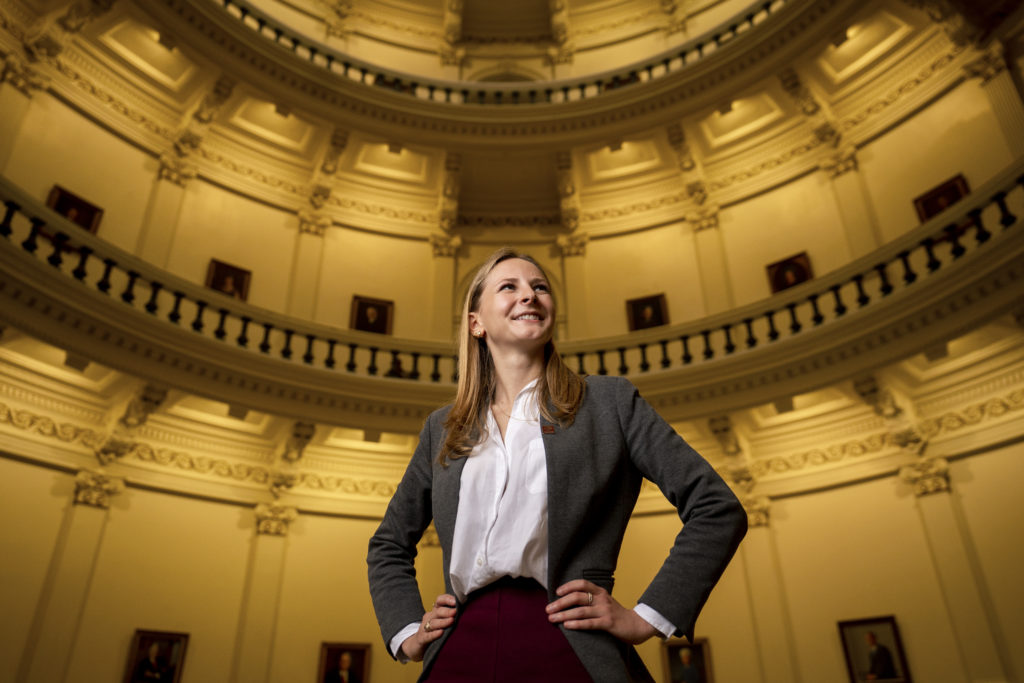 Student standing in the capitol building