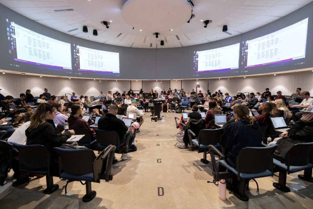 Students sitting in a circular classroom