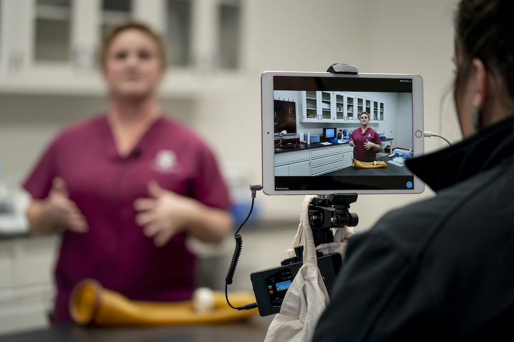 Woman records another woman for a video using an iPad