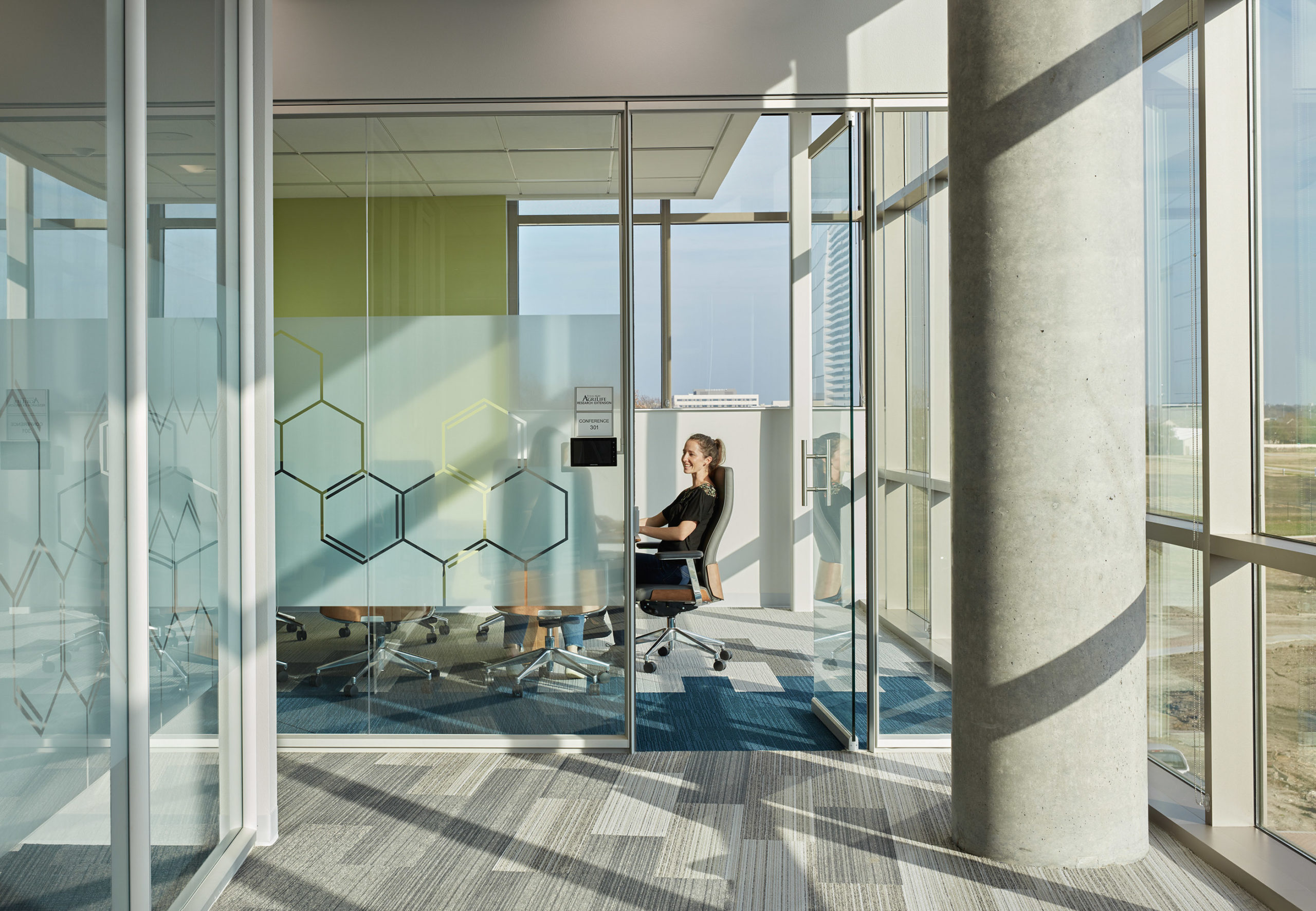 Woman sitting in an Agrilife Research Extension conference room