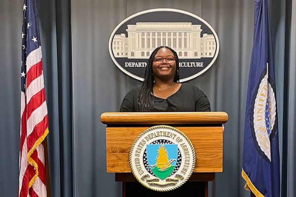 Mickeala Carter standing behind a podium