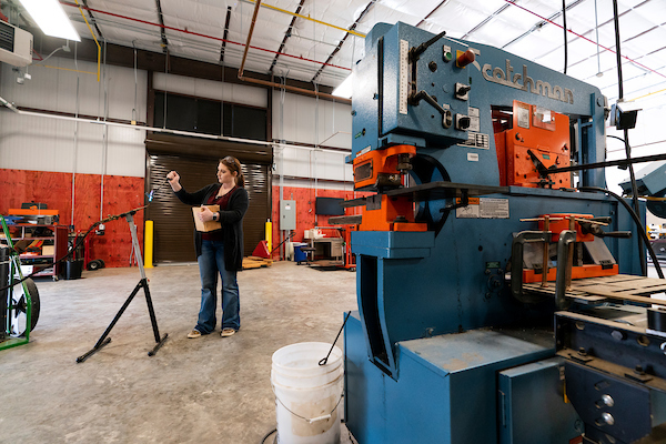 Women standing in large shop with agricultural machinery